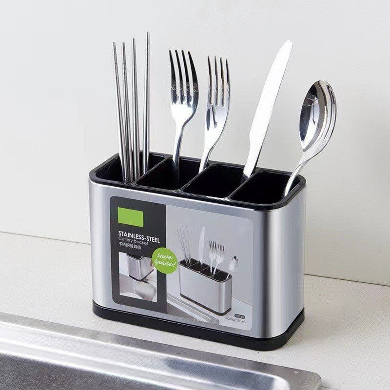 Silver cutlery organizer with drainage compartments holding chopsticks, forks, a knife, and a spoon on a counter