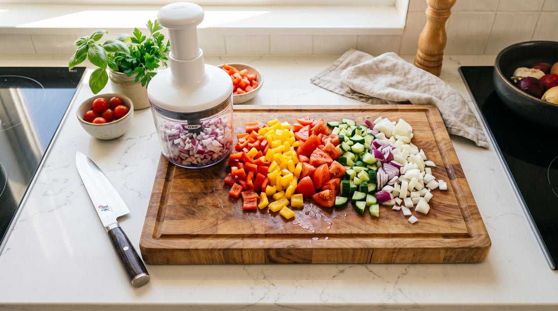 Vegetable chopper with freshly diced peppers and onions in a sunny modern kitchen