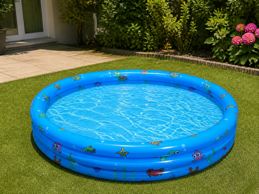Round blue inflatable pool set up on a level small backyard lawn