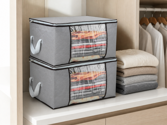 Two gray foldable clothes storage bags stacked in a bright organized closet