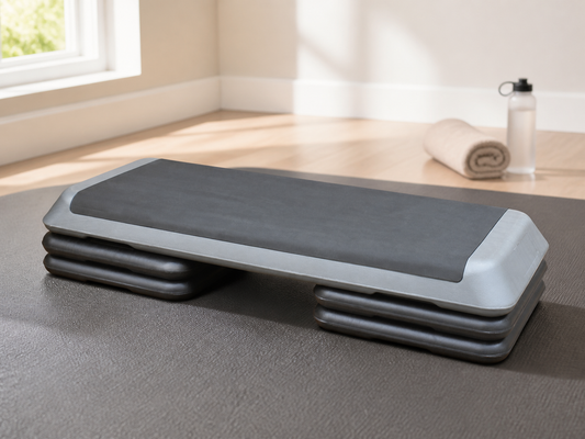 Gray adjustable aerobic step platform with four risers in a home workout space