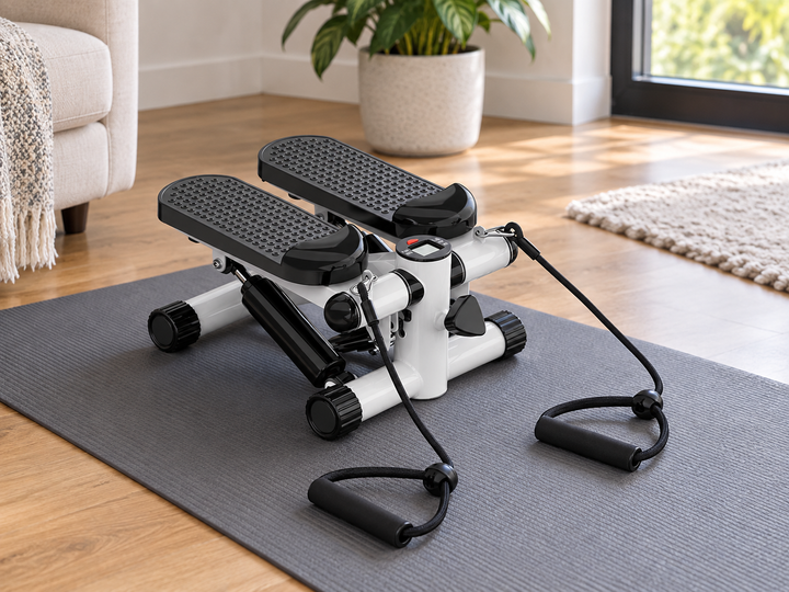 White and black mini stepper with LCD and two resistance cords on an apartment exercise mat