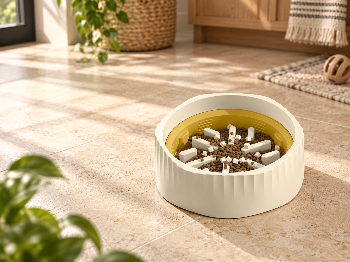 Cream and gold slow feeder bowl with radial maze pieces in a warm pet-friendly kitchen