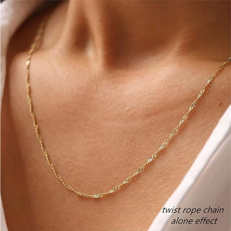 Gold twisted rope chain necklace worn alone on a model