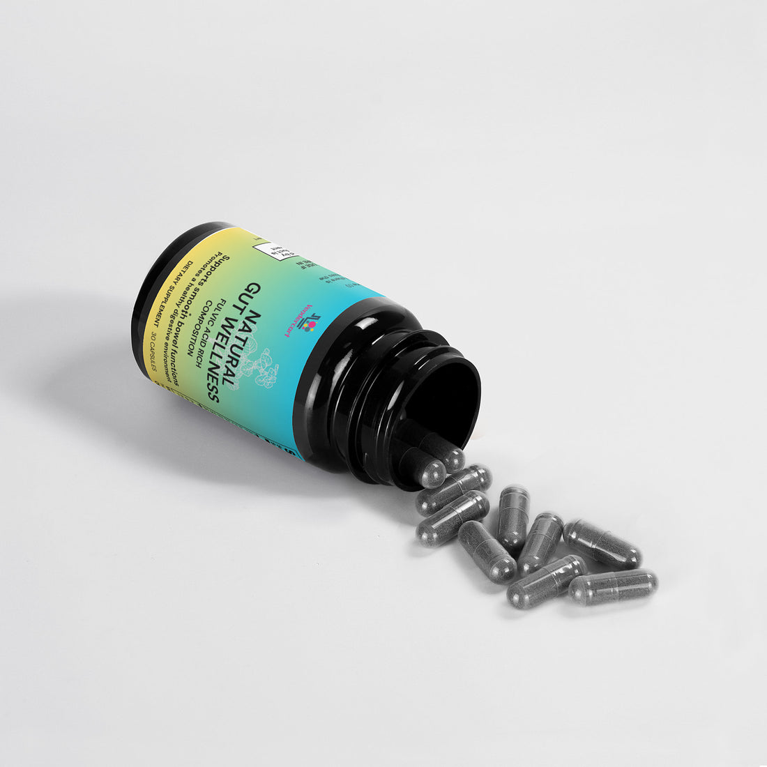 Natural gut wellness capsules on a counter with water glass