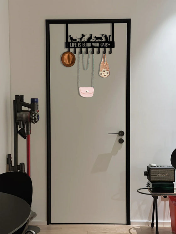 Cat hook rack hanging over a white door