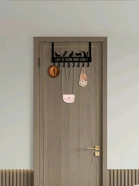 Cat hook rack over a brown door