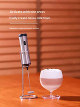 Milk frother whipping foam in a glass