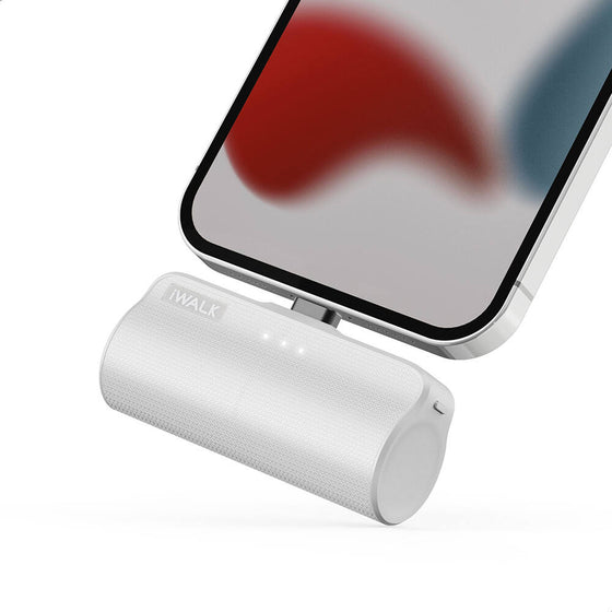 White mini power bank holding a phone upright while charging