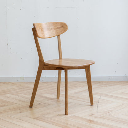 Modern oak dining chairs in a transitional dining room