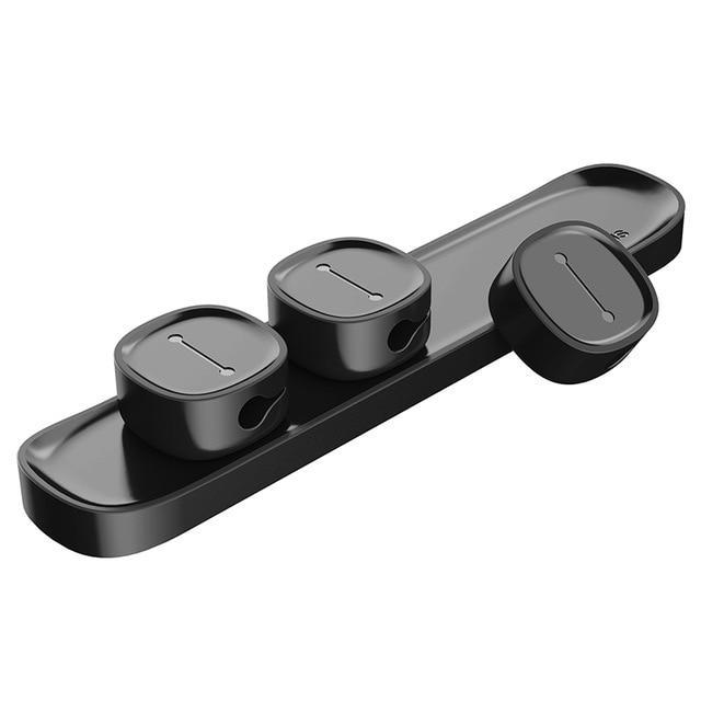 Several cable clips lined up showing the adhesive backing