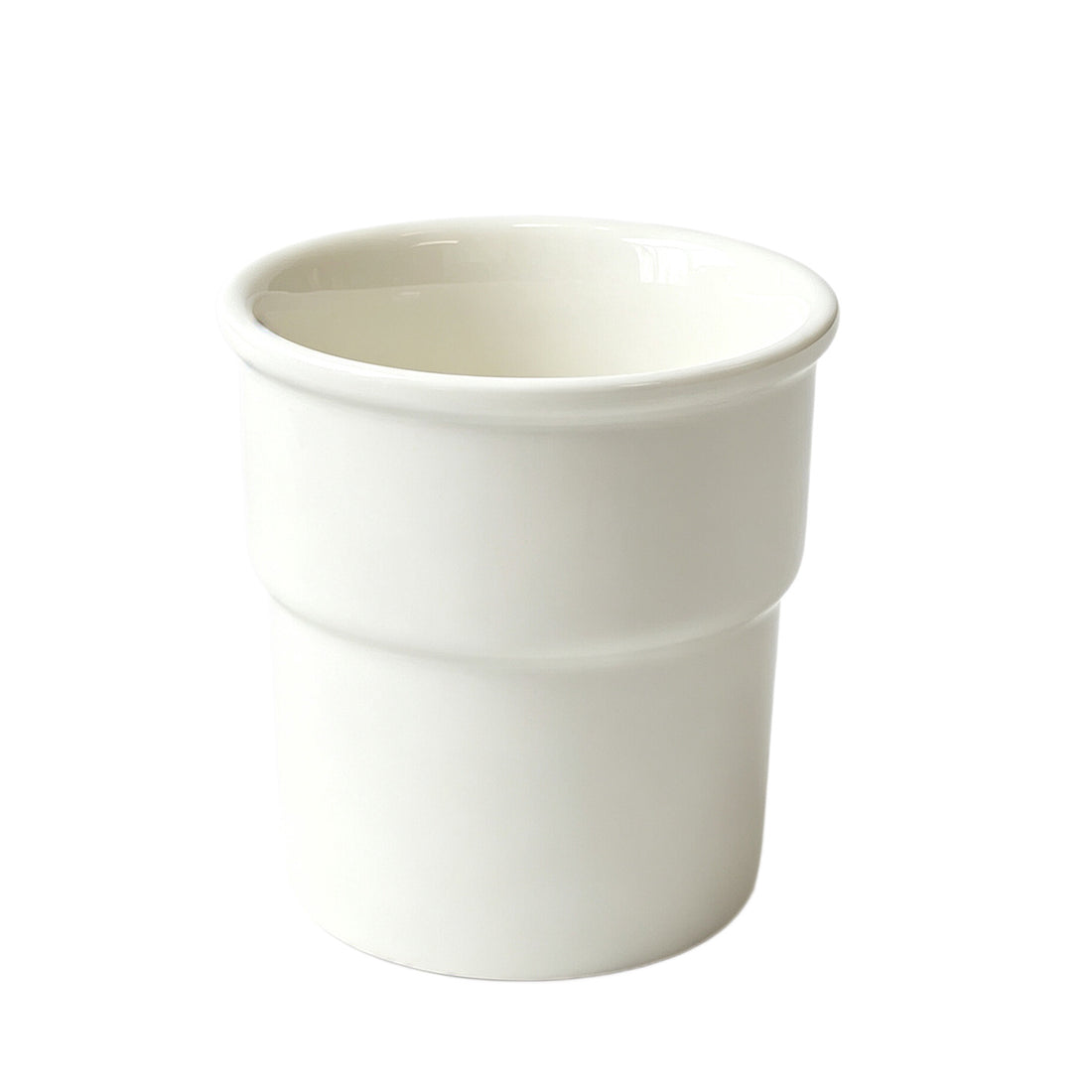Hand holding a white ceramic cup