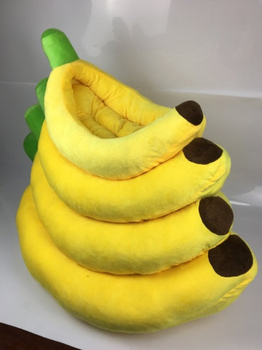 Small dog resting half inside the banana bed