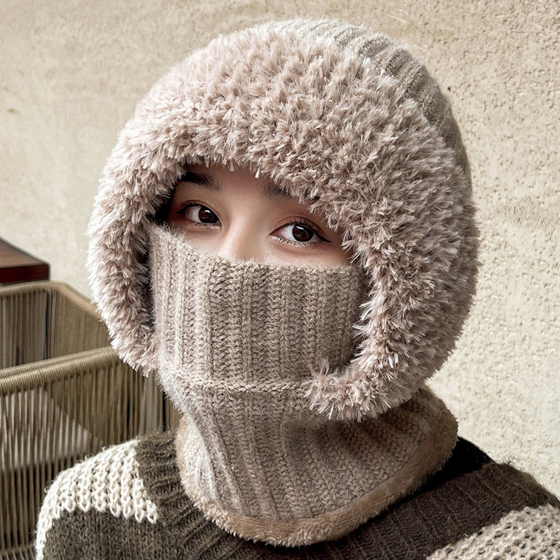 Woman wearing a light brown knit hood covering her nose and mouth