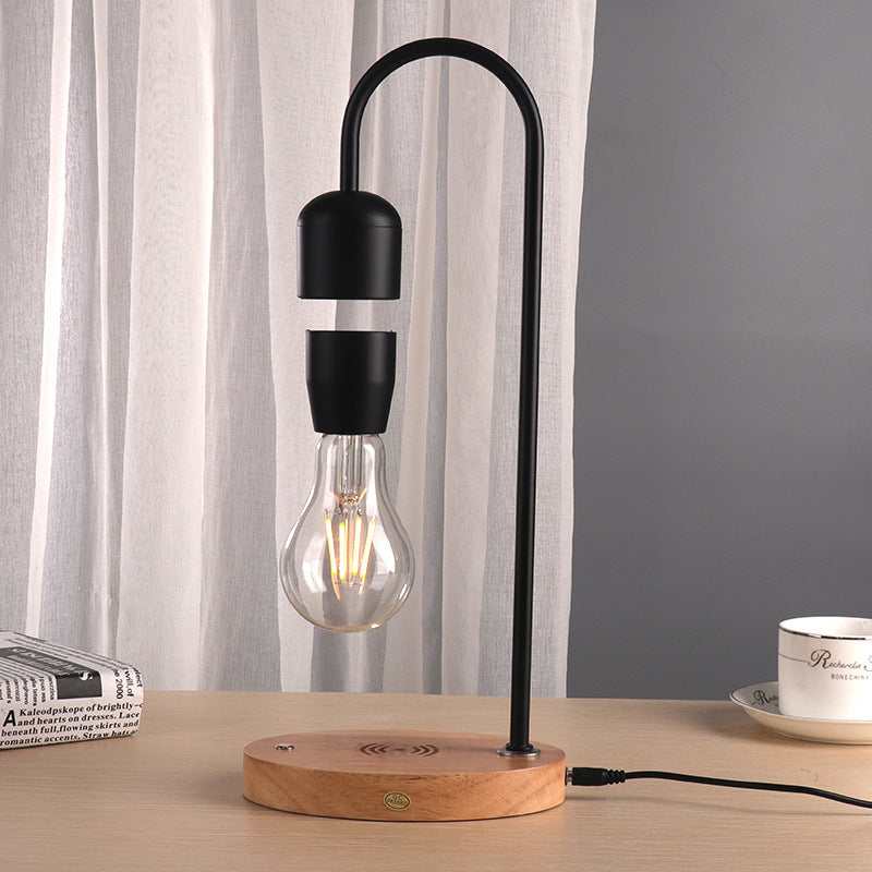 Magnetic levitating LED light bulb floating above a black base, photo 6