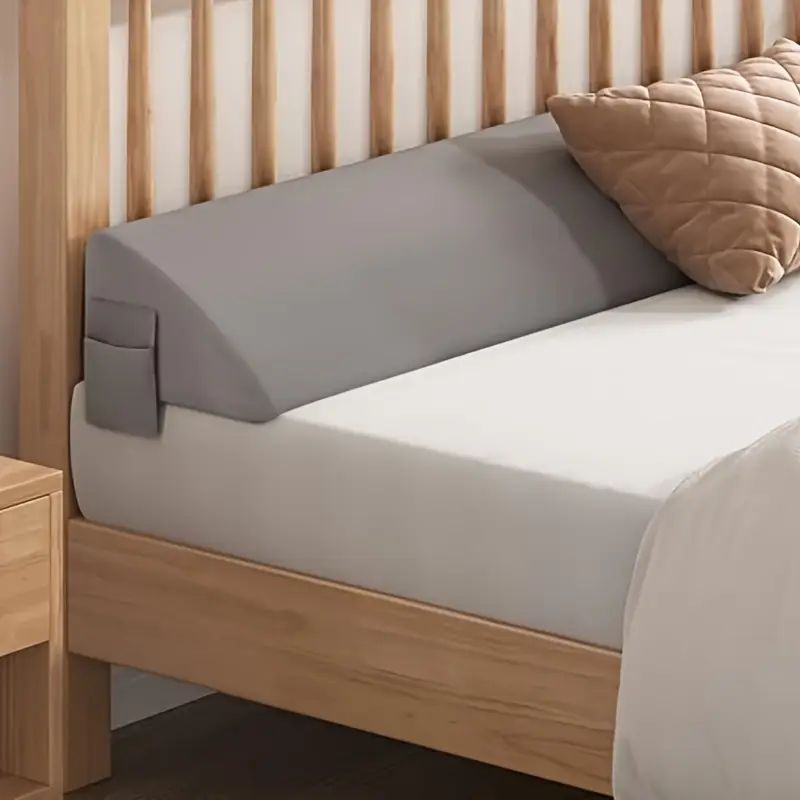 Gray gap filler with a side pocket on a wooden bed