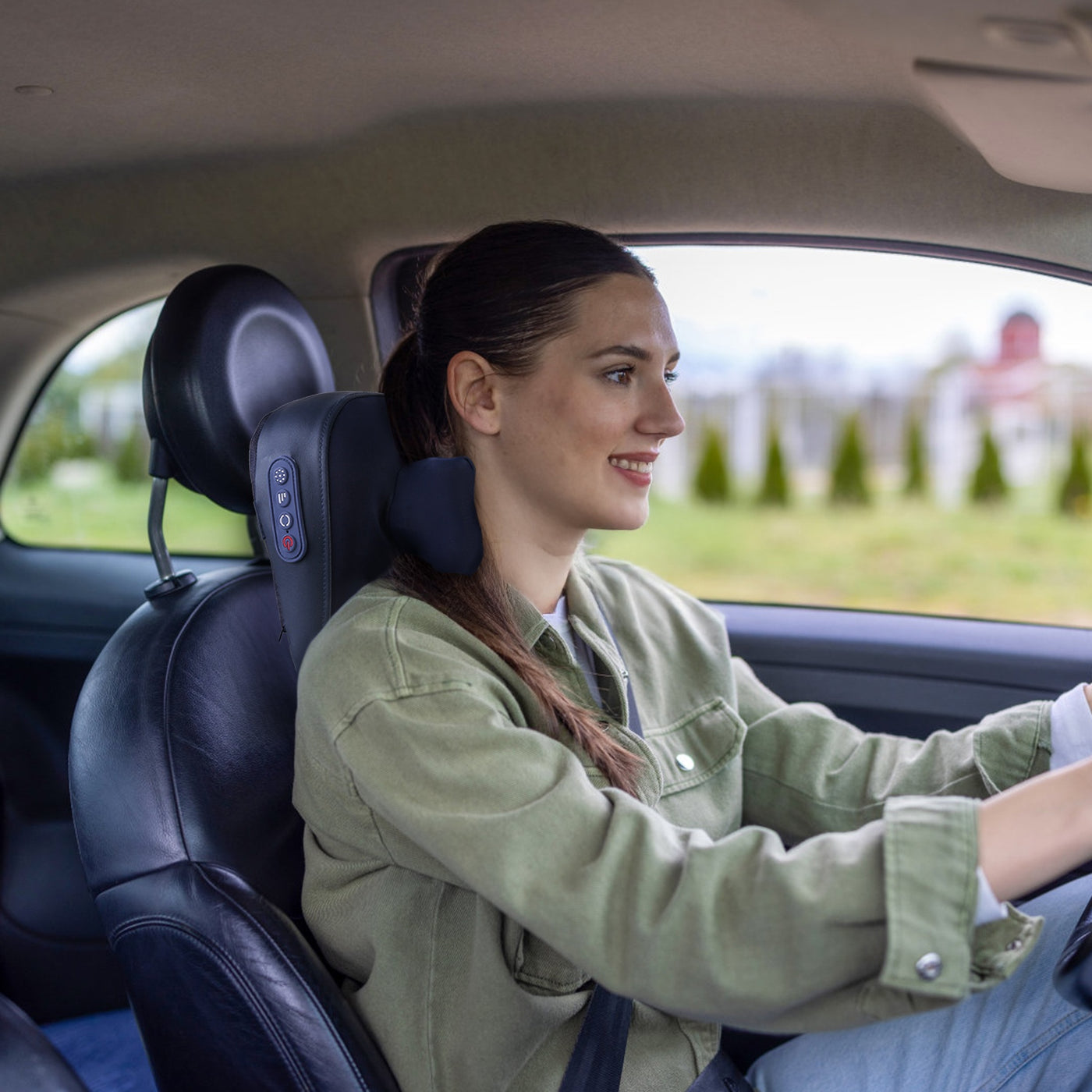 Cordless neck shoulder massager in use in car