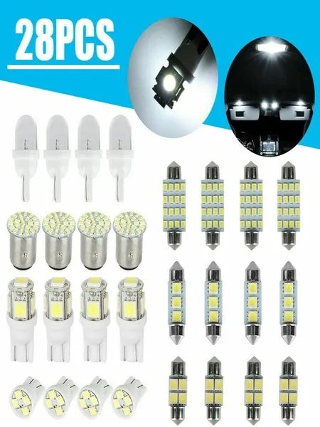 Assorted white LED wedge and festoon bulbs with a lit cabin