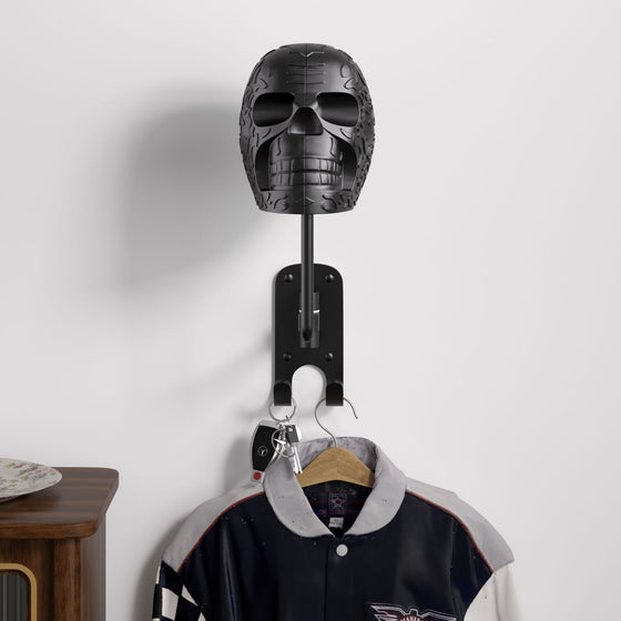 Black skull helmet holder on a wall with a hook and a jacket hanging below