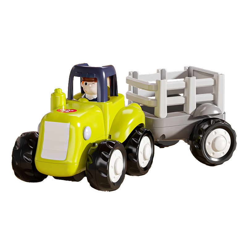 Green toy tractor with a gray trailer and driver figure