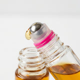 PureGlow castor oil roll-on travel size in hand