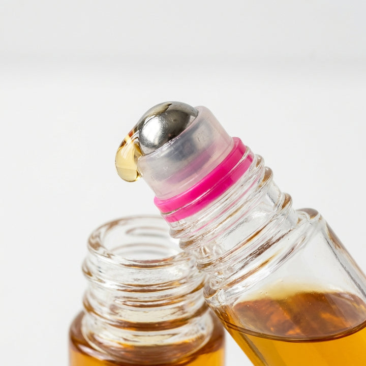 PureGlow castor oil roll-on travel size in hand