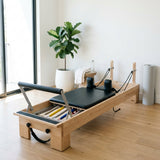 Pilates reformer machine set up in a home workout space