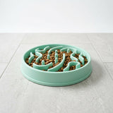 Dog using interactive slow feeder puzzle toy