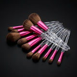 10-piece makeup brush set with clear crystal handles and pink ferrules on a dark background