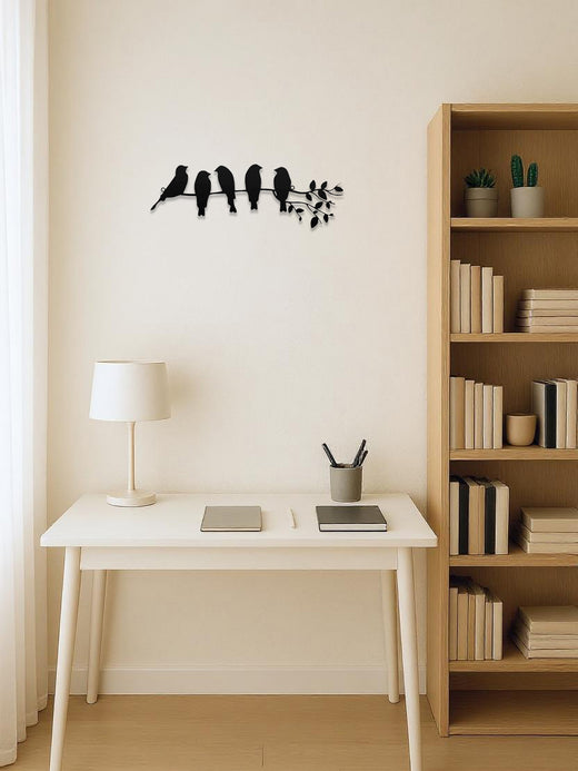 Metal bird wall art hung above a console table