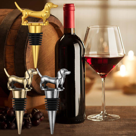 Gold and silver dachshund wine bottle stoppers with a wine bottle and glass