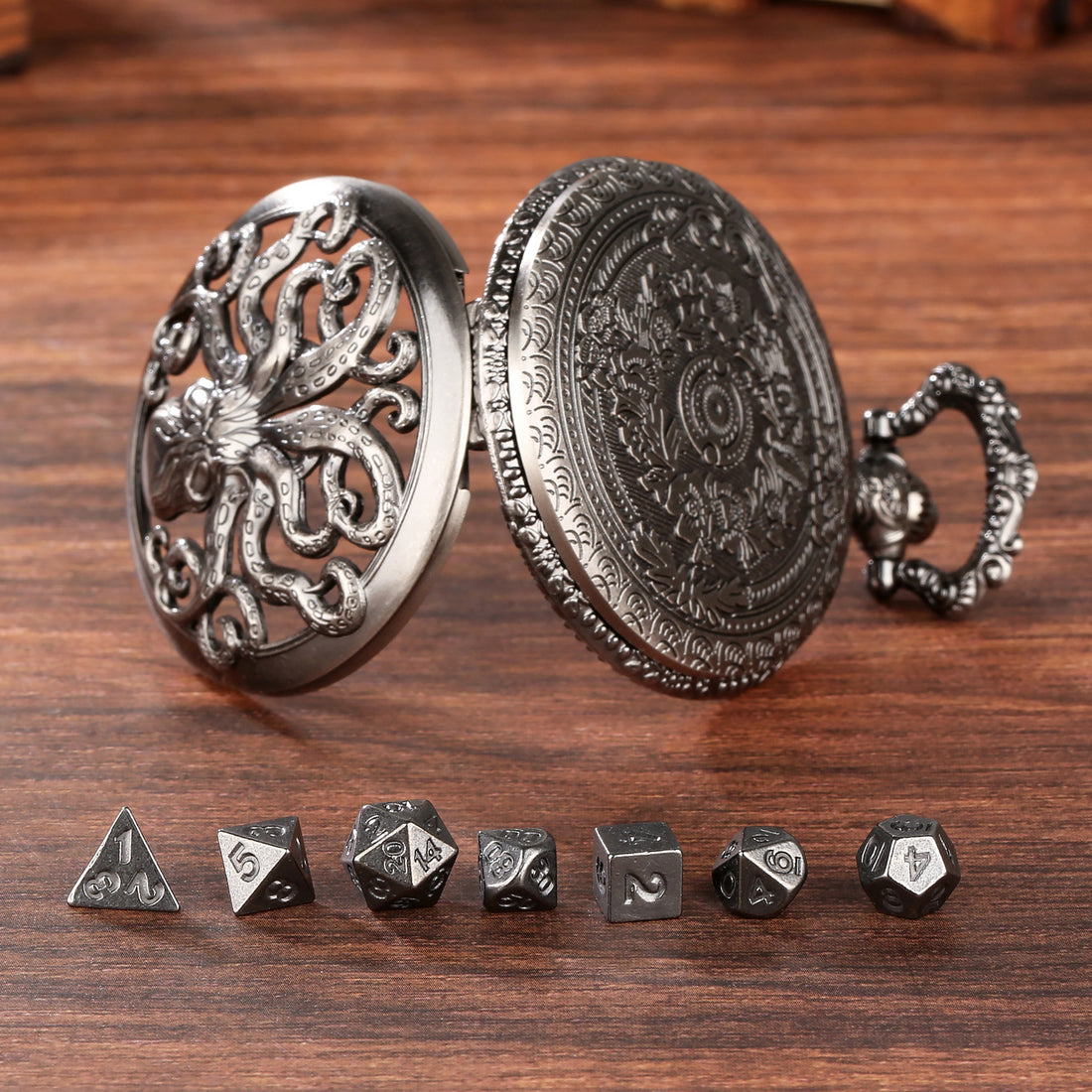 Dark silver octopus dice case open beside 7 mini metal dice on wood
