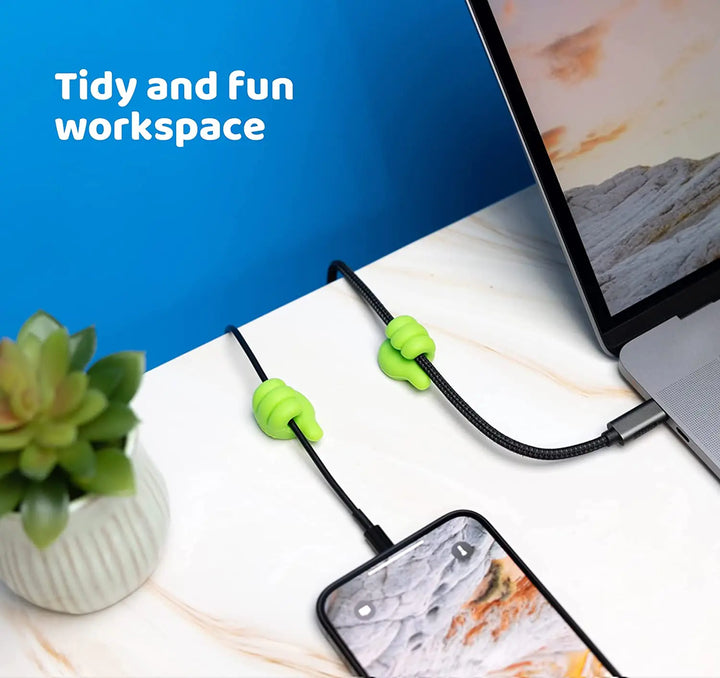 Several clips lined up along a desk holding multiple cables organized