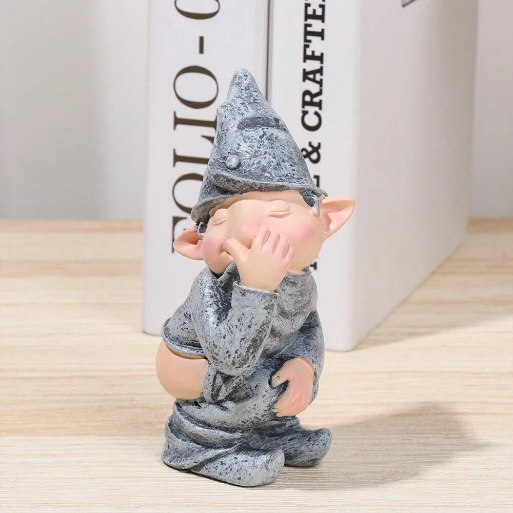Pooping gnome statue on a bookshelf as indoor decor