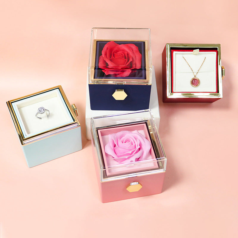 Pink and blue rose jewelry boxes with pendant necklaces in the drawers