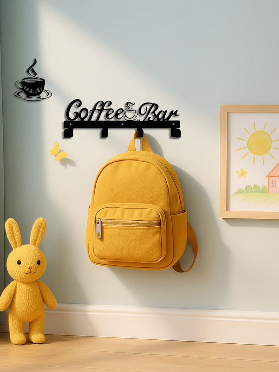 Coffee Bar hook sign holding a yellow backpack