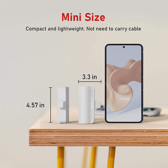 Mini power bank size guide next to a phone on a wooden shelf