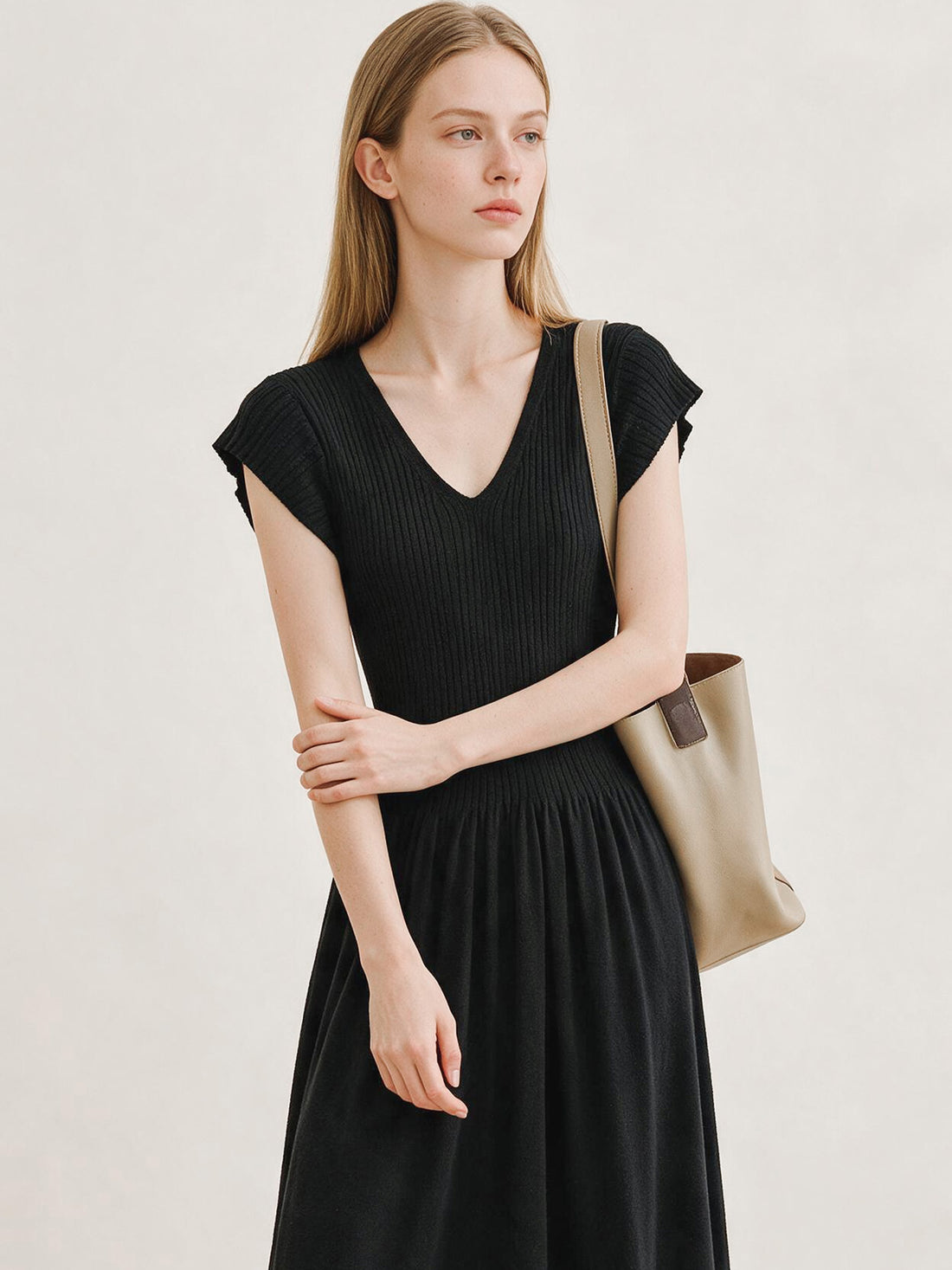 Black ribbed knit V-neck dress with flutter sleeves and pleated skirt, photo 6