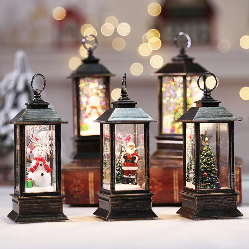 Christmas LED lanterns with Santa and tree scenes beside mini Christmas trees
