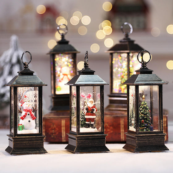 Christmas LED lanterns with Santa and tree scenes beside mini Christmas trees