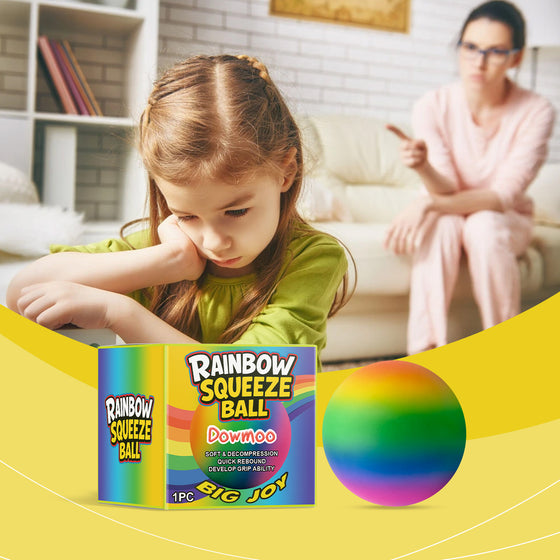 Girl doing homework with the rainbow stress ball and box on the table