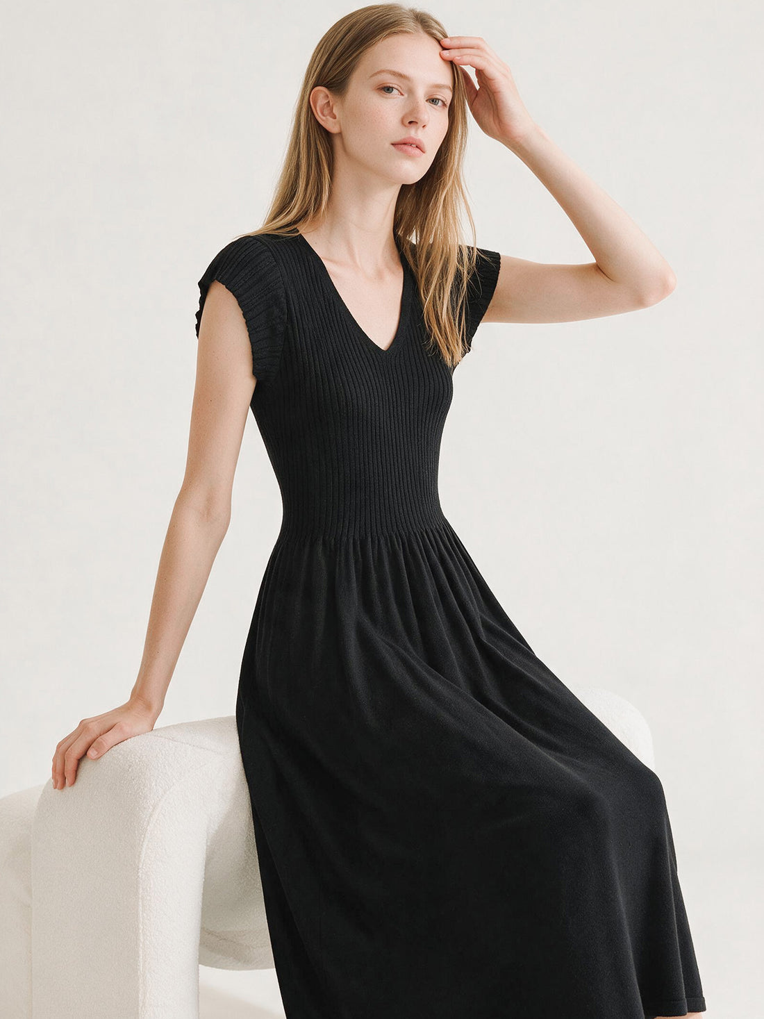 Black ribbed knit V-neck dress with flutter sleeves and pleated skirt, photo 4