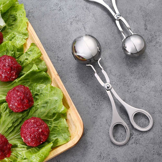 Stainless steel meatball maker shown on white background