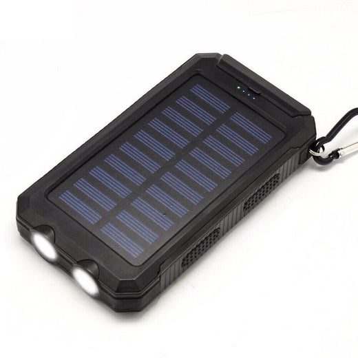 Solar power bank charging a phone via USB cable