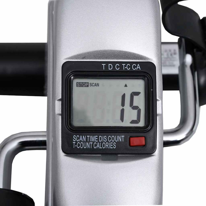Pedal bike trainer compact size next to a chair