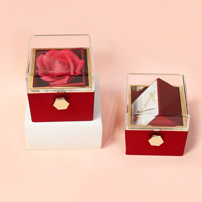 Red rotating rose gift box with drawer open beside its red paper box
