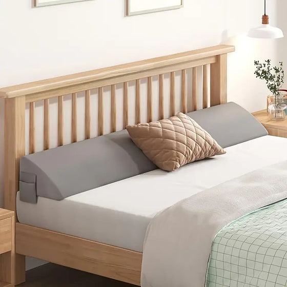 Gray bed gap filler pillow along a wooden headboard