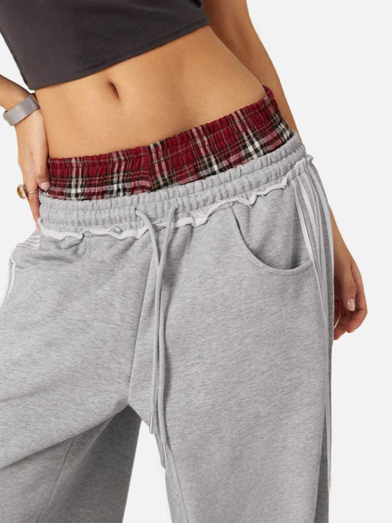 Close-up of the plaid waistband and drawstring on gray pants