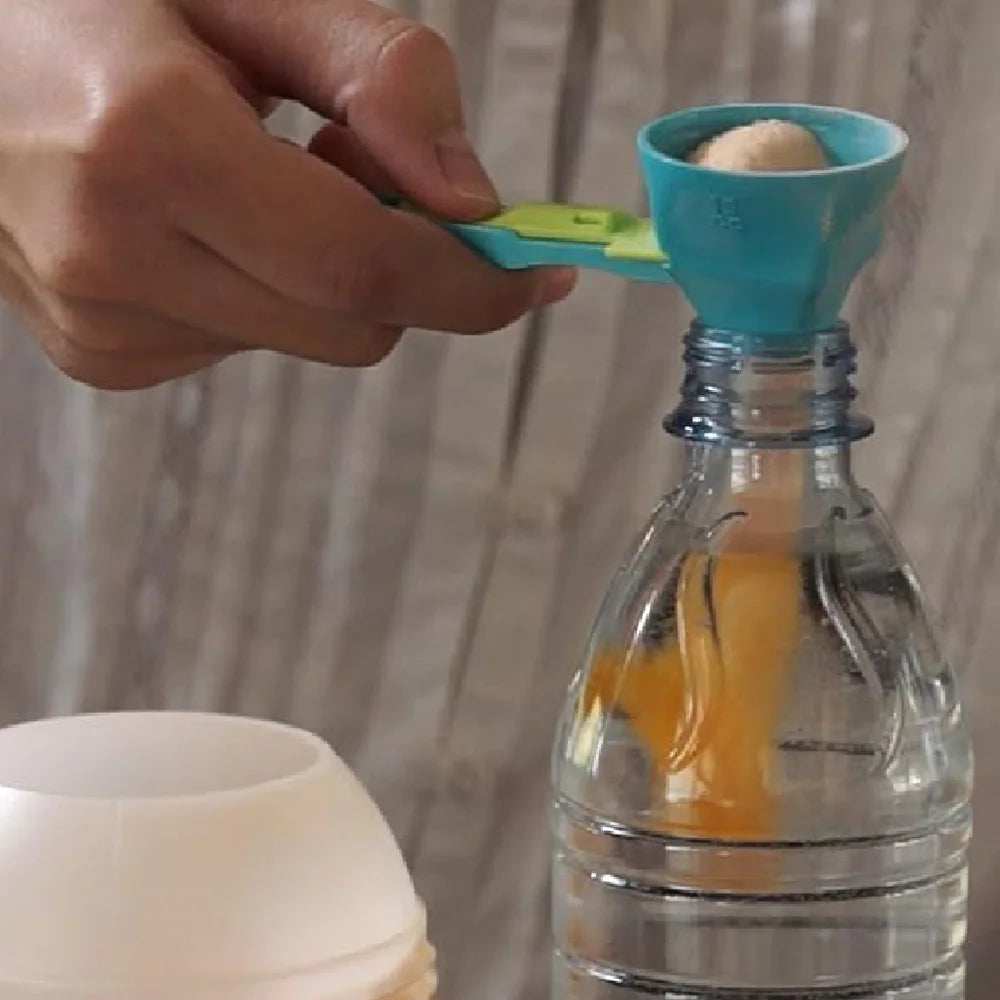 Adjustable teal measuring scoop with a sliding plunger that pushes dry ingredients out without spilling
