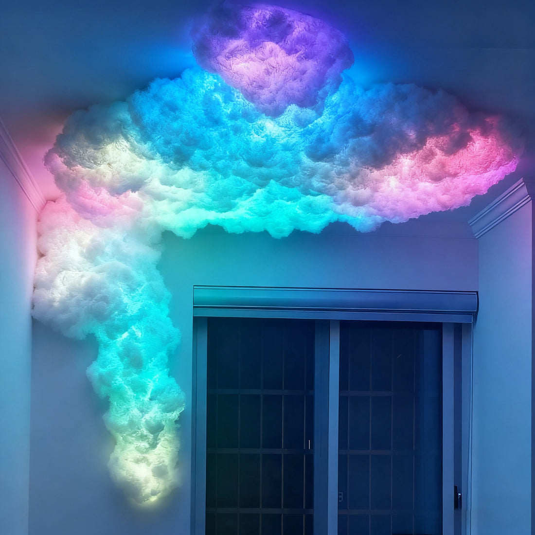 Blue and pink cloud lamp flowing from the ceiling down beside a window